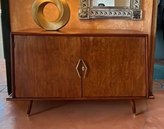 Wooden cabinet with decorative elements on a wooden floor